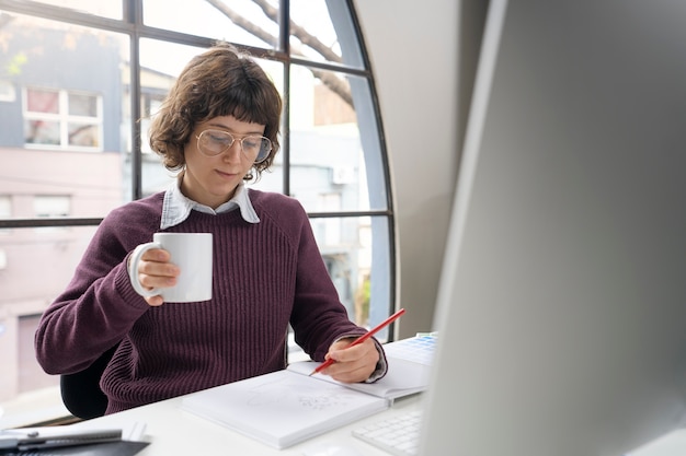 Graphic designer making a logo on a notebook