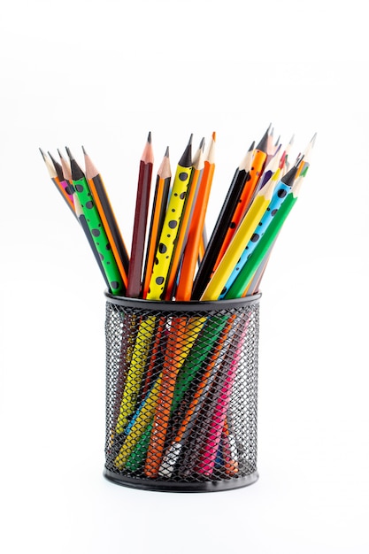 Free photo graphite drawing pencils bright lined inside black basket on white desk