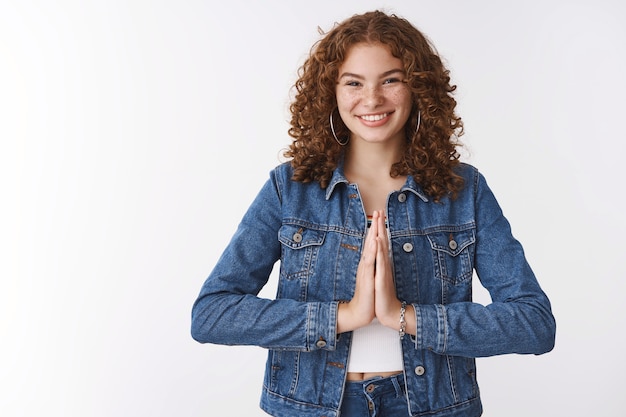 Free photo grateful young charming happy redhead girl thanking bowing polite press palms together supplication pray gesture smiling broadly appreciate help, standing white background delighted