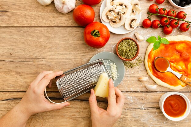 Grating cheese with other pizza ingredients