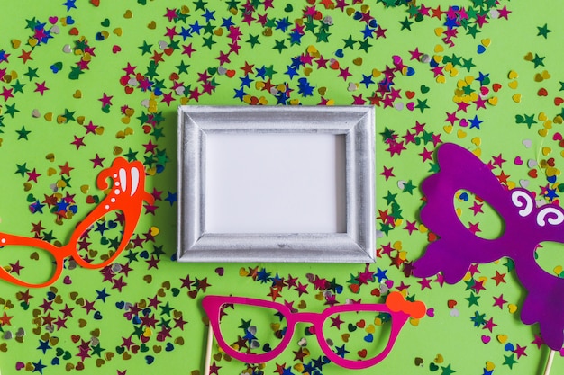 Gray photo frame with confetti and colorful glasses