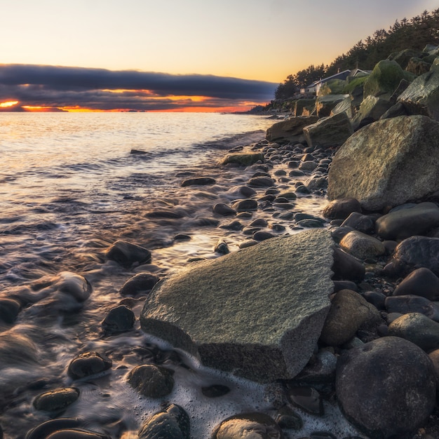 Free Photo gray rocks on seashore during sunset