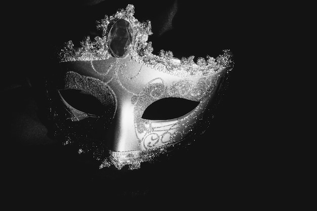 Gray venetian mask on a dark background