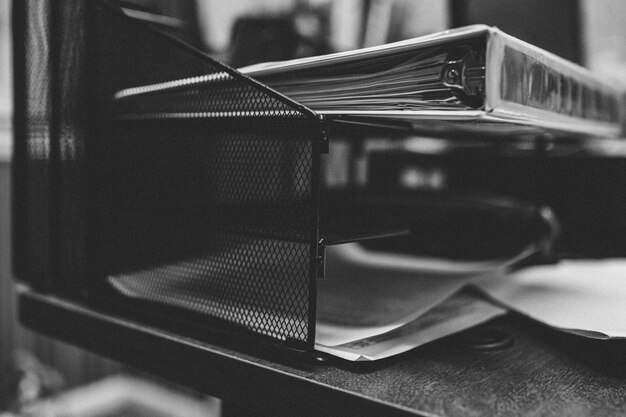 Grayscale closeup shot of folders and papers