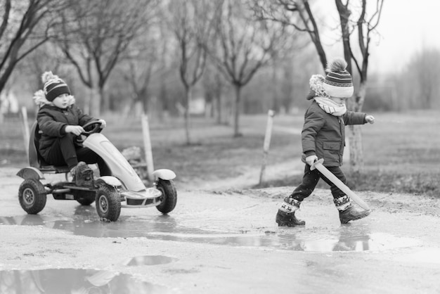 Grayscale image kids playing outside