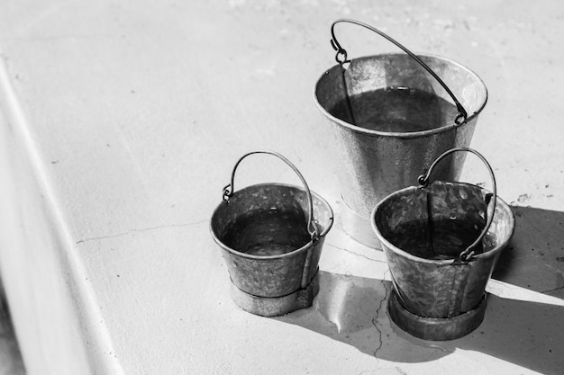 Free Photo grayscale shot of different sizes of metal buckets