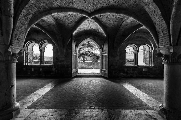 Free Photo grayscale shot inside of abbey of saint galgano in tuscany italy with arch walls design