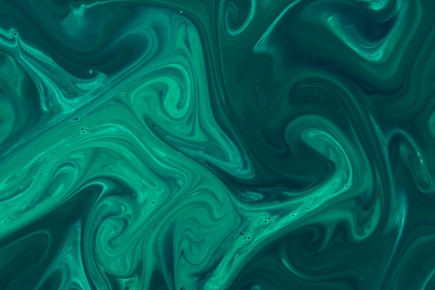 Green acrylic paint on water surface background