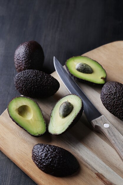 Green avocados on cutting board