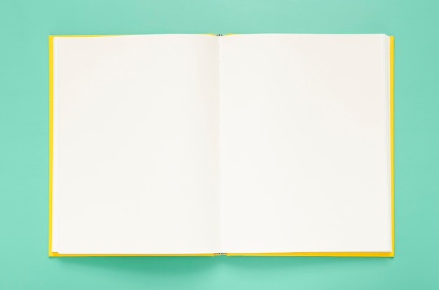 Free photo green background with empty notebook