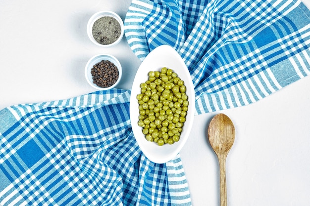 Free Photo green beans in a white cup with spices around. 