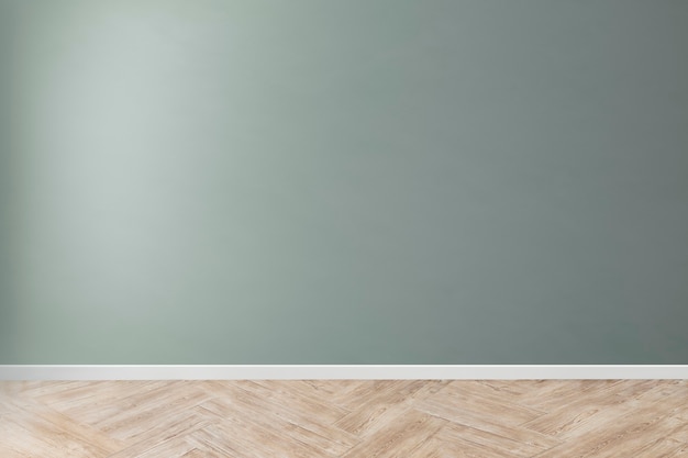 Free photo green blank concrete wall mockup with a wooden floor