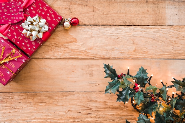 Free photo green branch with fairy lights near present boxes