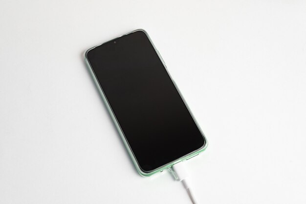 Green cell phone connected to USB cable type C - Charging