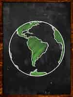 Free photo green earth on blackboard globe