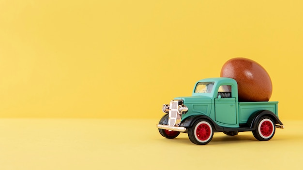 Free Photo green easter car with brown egg and copy space