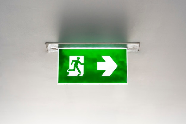 Free Photo green emergency exit sign on the ceiling