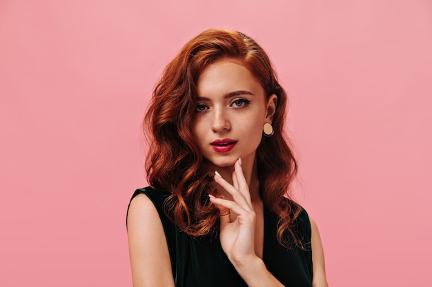 Green eyed woman in velvet outfit looks at front