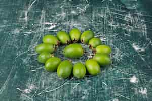 Free photo green feijoa fruits on marble surface.