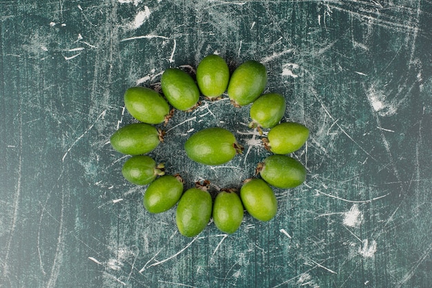 Free photo green feijoa fruits on marble surface.