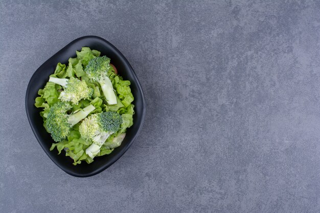 Green fresh broccoli isolated on blue surface