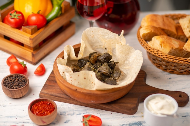 Green grape leaves stuffed with meat, rice, herbs, onion and cooked in olive oil, served with lavash and bread.yarpag dolmasi, yaprak sarmasi