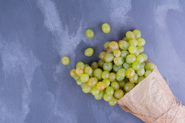 Green grapes in a paper wrap.