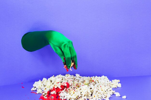 Green hand picking popcorn