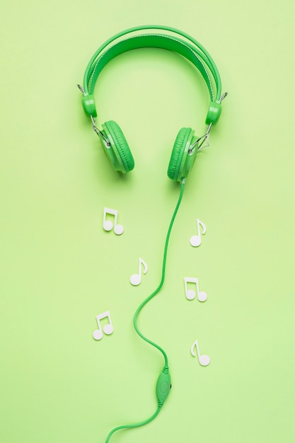 Free Photo green headphones with white musical notes