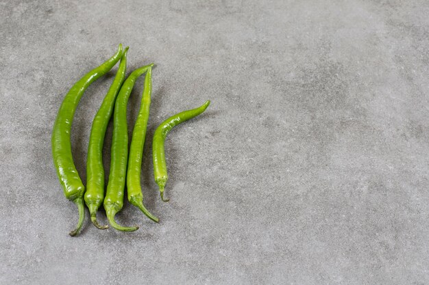 Green hot pepper , on the marble table. 