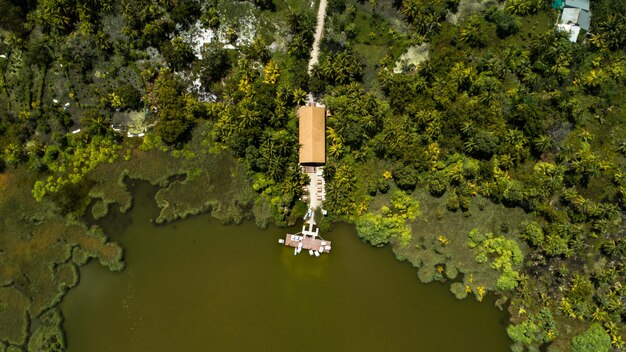 Green lake in the middle of an island sorrounded by trees and house in Maldives