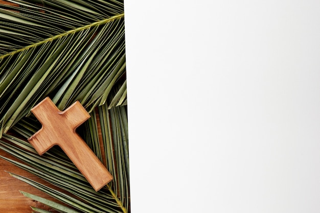 Green leaves and cross arrangement top view