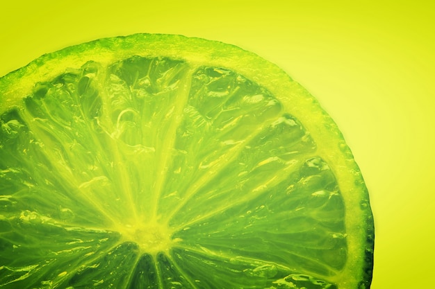 Green lemon in a yellow background