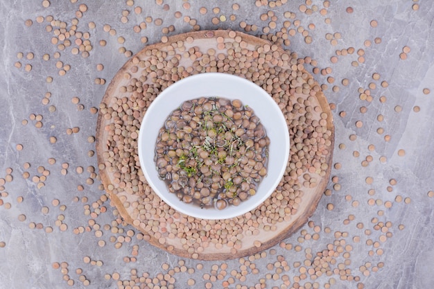 Free photo green lentil beans soup in broth in a white plate.