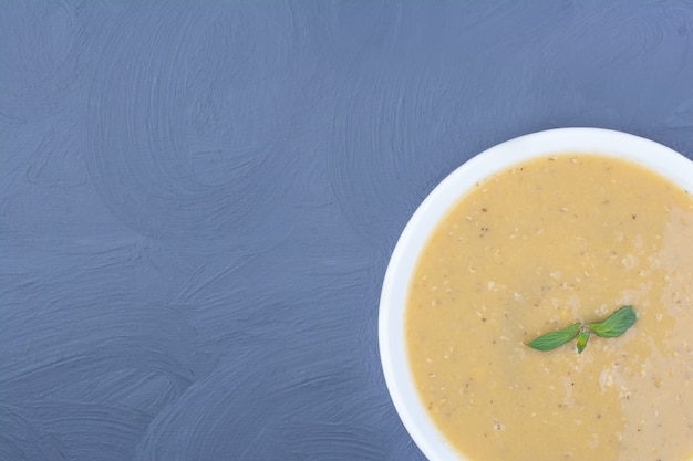 Green lentil beans soup in a white plate.