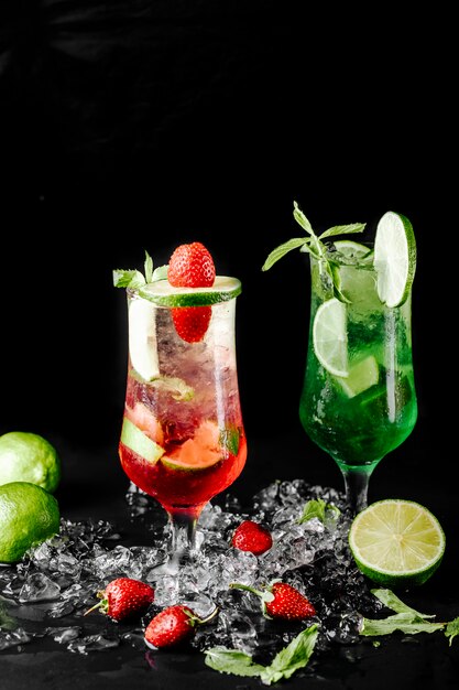 Green lime mojito with mint and red berry cocktails.