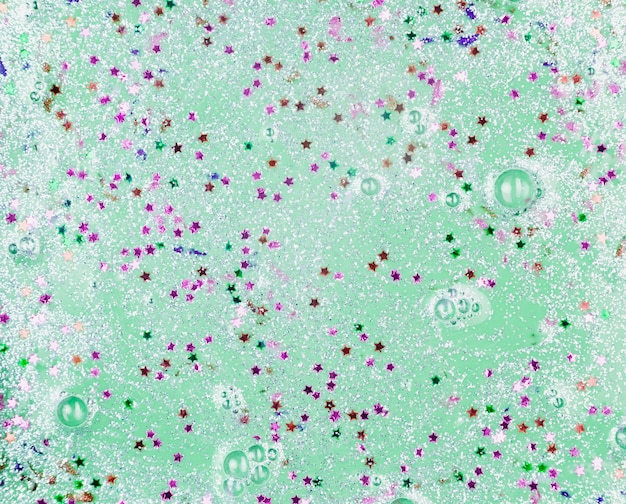 Green liquid with blobs and ornamental stars