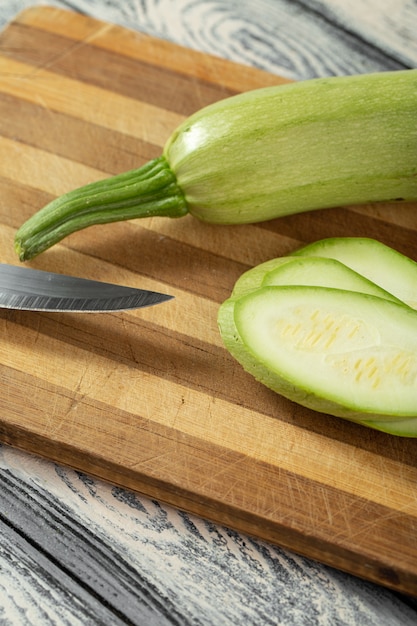 Green marrow fresh ripe on wooden desk and grey background