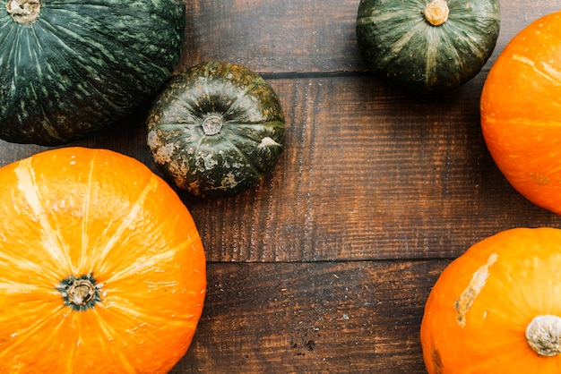 Free photo green and orange squashes on table