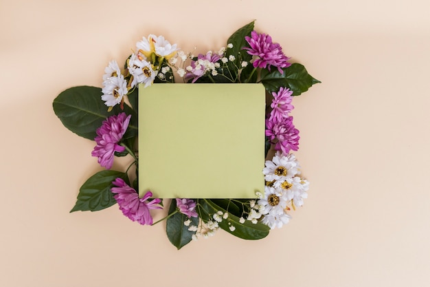 Free Photo green paper and flowers