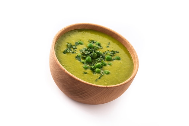 Green pea soup in a bowl isolated