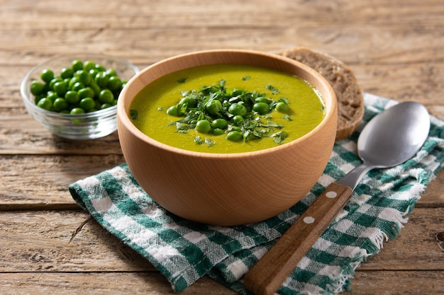 Green pea soup in a wooden bowl