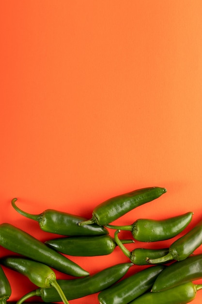 Green pepper spicy fresh on orange background