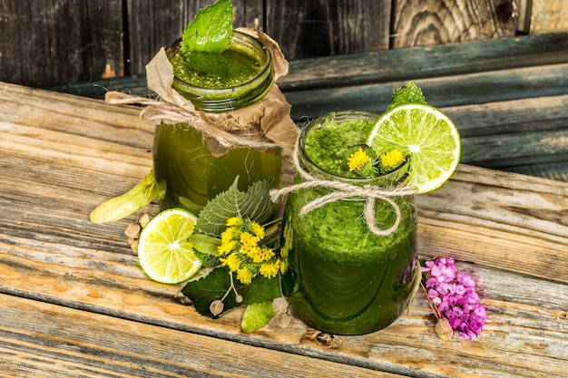 green smoothie in a jar with lime, kiwi and berry