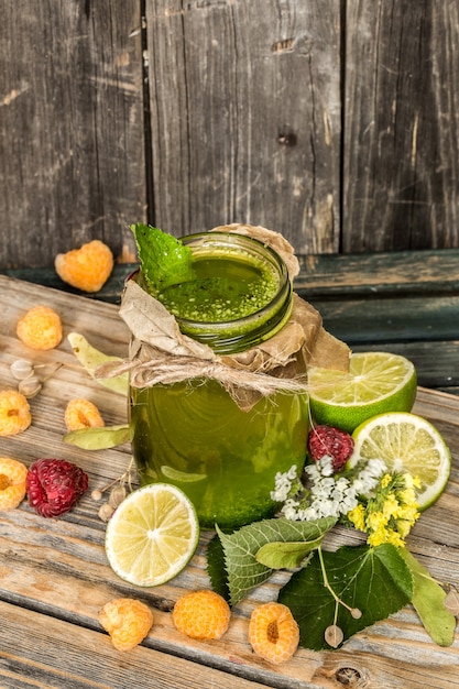 green smoothie in a jar with lime, kiwi and berry