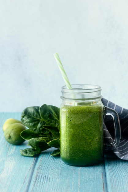 Green smoothie on wooden table