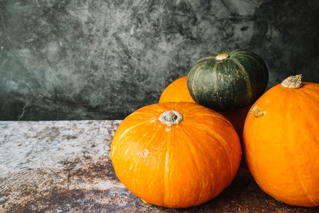 Free photo green squash on orange pumpkins