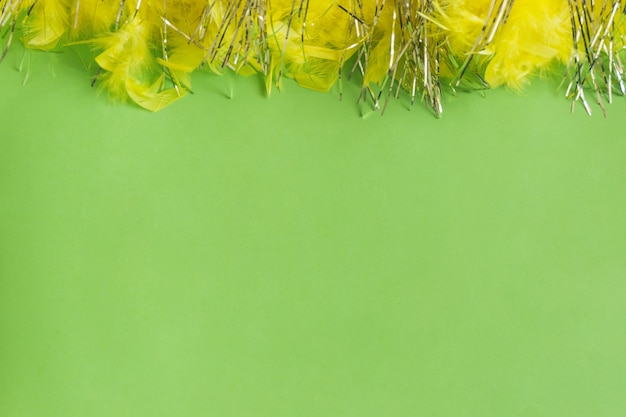 Green table with yellow feathers on top