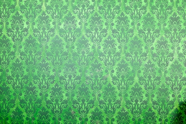 Free photo green vintage pattern on old wall. rich vintage retro pattern interior