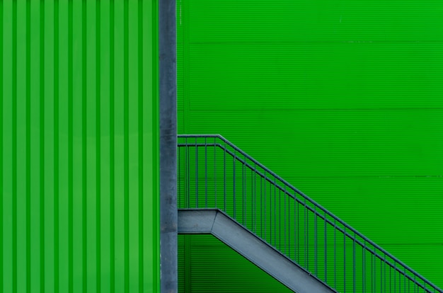 Green wall with metal stairs